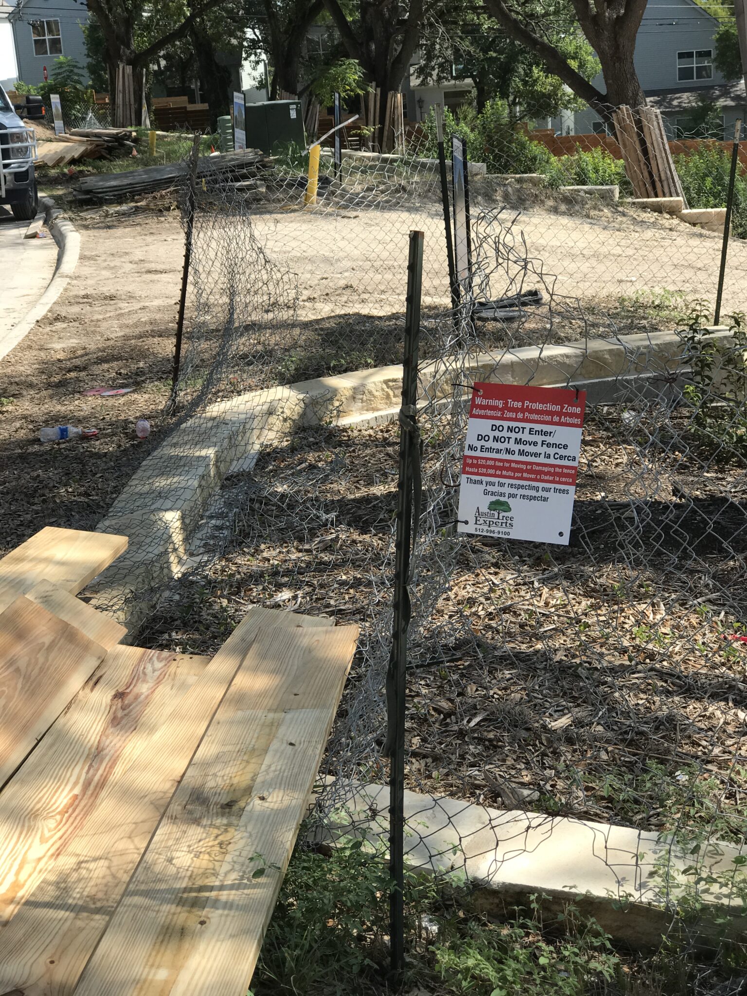 Tree protection fencing with Austin Tree Experts signage at a construction site